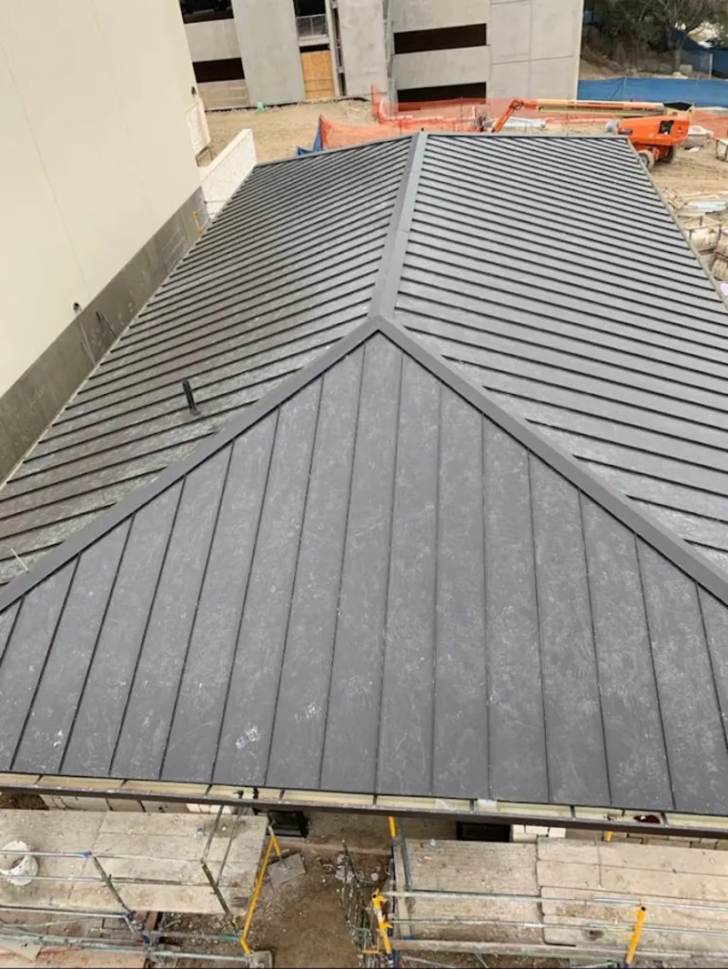 Commercial metal roof construction with crane equipment in Logansport